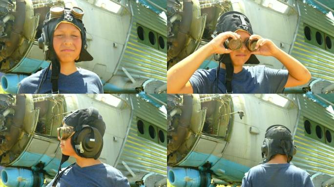 男孩在一架被毁的老式飞机附近，戴着老式飞行员的头盔和飞行护目镜