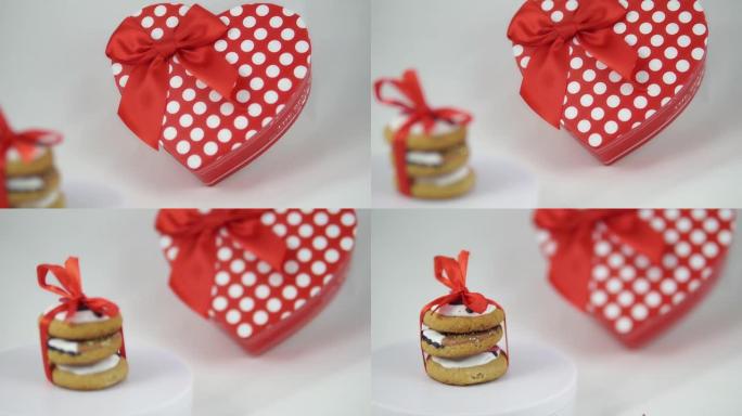 红色浪漫装饰的饼干和一个礼盒上孤立的白色，特写。情人节概念