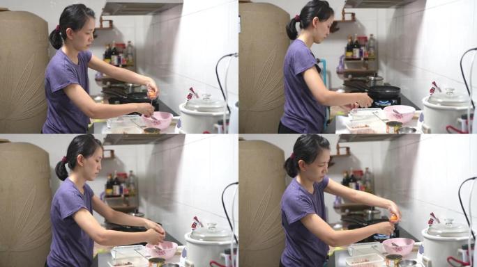 亚洲女性在家厨房做饭。