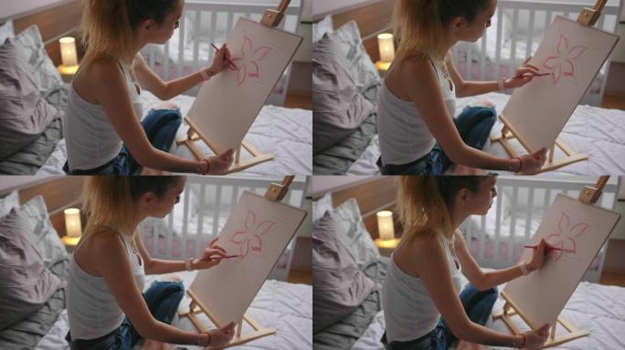 年轻女子在卧室画画。在家工作的艺术家。在新型冠状病毒肺炎大流行封锁期间呆在家里。
