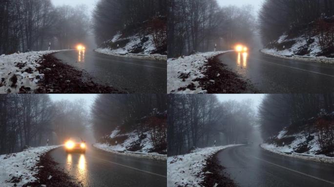 汽车在恶劣天气下在冬季蜿蜒的山路上行驶，有雾且能见度低，危险条件下行驶