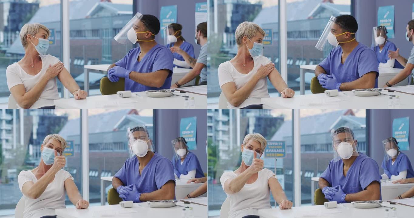 4k视频片段，一名妇女在新型冠状病毒肺炎疫苗接种中心接受注射后竖起大拇指