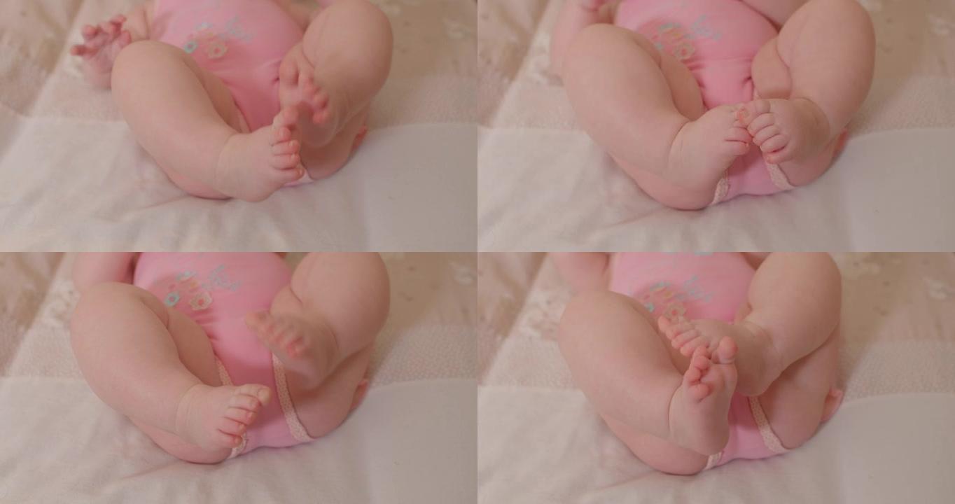婴儿的脚运动。粉色衣服。等待改变。