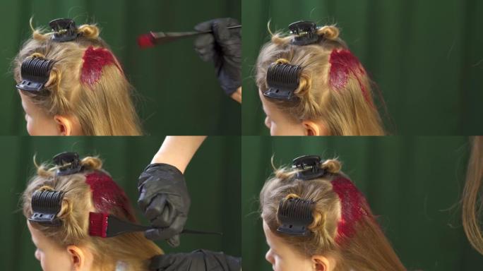 染发后脑勺的发根。戴着黑手套的女理发师在一个小女孩的头上涂上油漆。把时髦小子的颜色改成时髦的鲜艳。