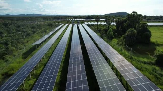 带阳光的太阳能电池板农场 (太阳能电池) 的4k鸟瞰图，无人机飞行飞越太阳能电池板领域泰国可再生绿色