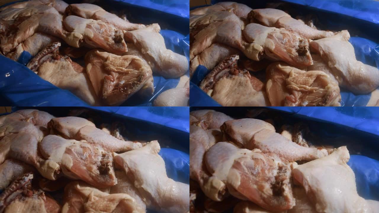 一个装满冷冻鸡腿的盒子的特写视图。用冰覆盖的冷冻生鸡肉。4k视频