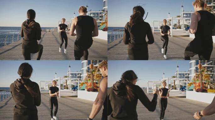 健身教练向一群运动的人展示有氧运动，在码头上跑步，享受运动训练