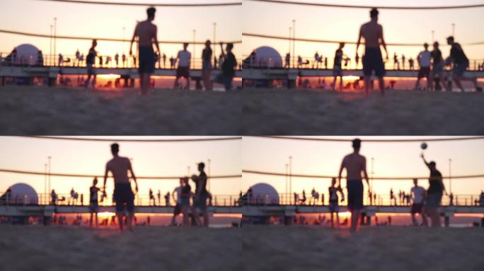 年轻的匿名人士在日落黄金时段在沙滩上打排球
