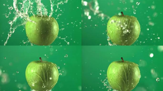水滴超级慢动作青苹果。以1000 fps的速度在高速相机上拍摄