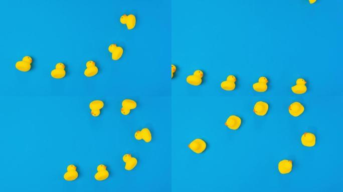 蓝色背景上的黄色橡皮鸭。最小夏季概念。停止运动，顶视图