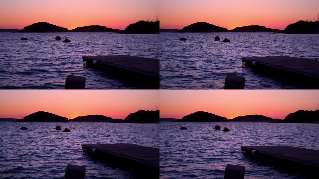 阿尔巴尼亚惊人的紫色日落，克萨米尔。平静的离子海。完美的兰西角背景
