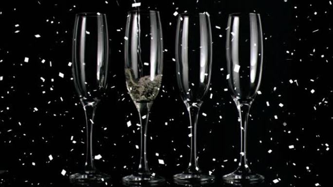 香槟杯和五彩纸屑落在黑色背景上的动画