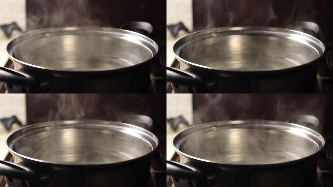 蒸汽从带有水的锅中升起特写，背景模糊