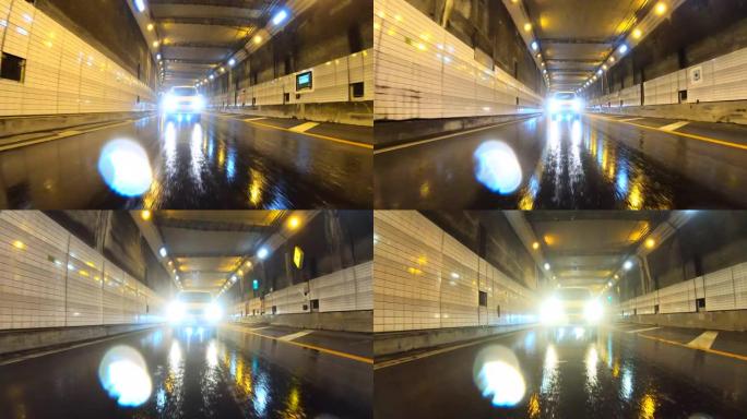 雨天开车穿过高速公路隧道。向后看