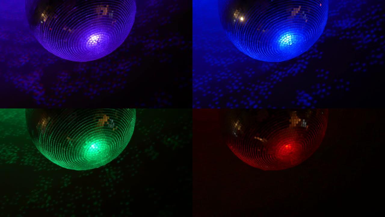 旋转的镜面球迪斯科球的特写镜头，彩色灯光反射。