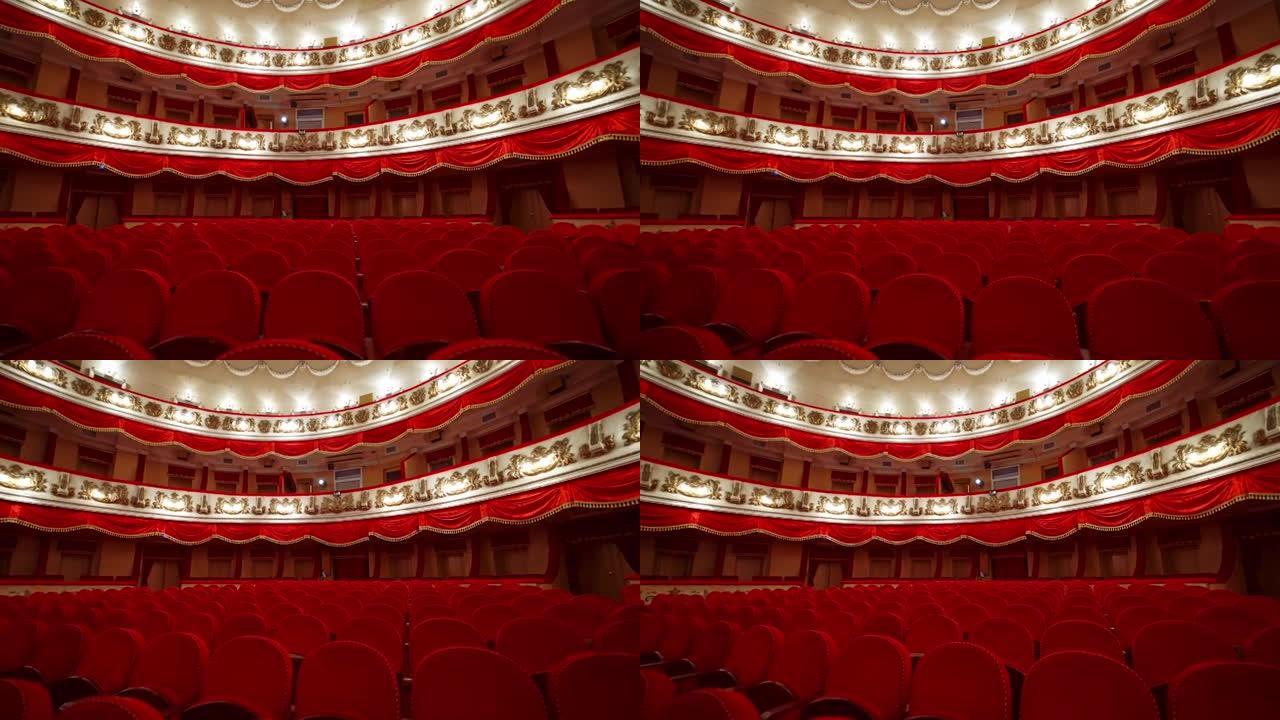 古典剧院的内部。空荡荡的大厅，有红色舒适的座位，没有观众。红色和白色的大型会议厅。
