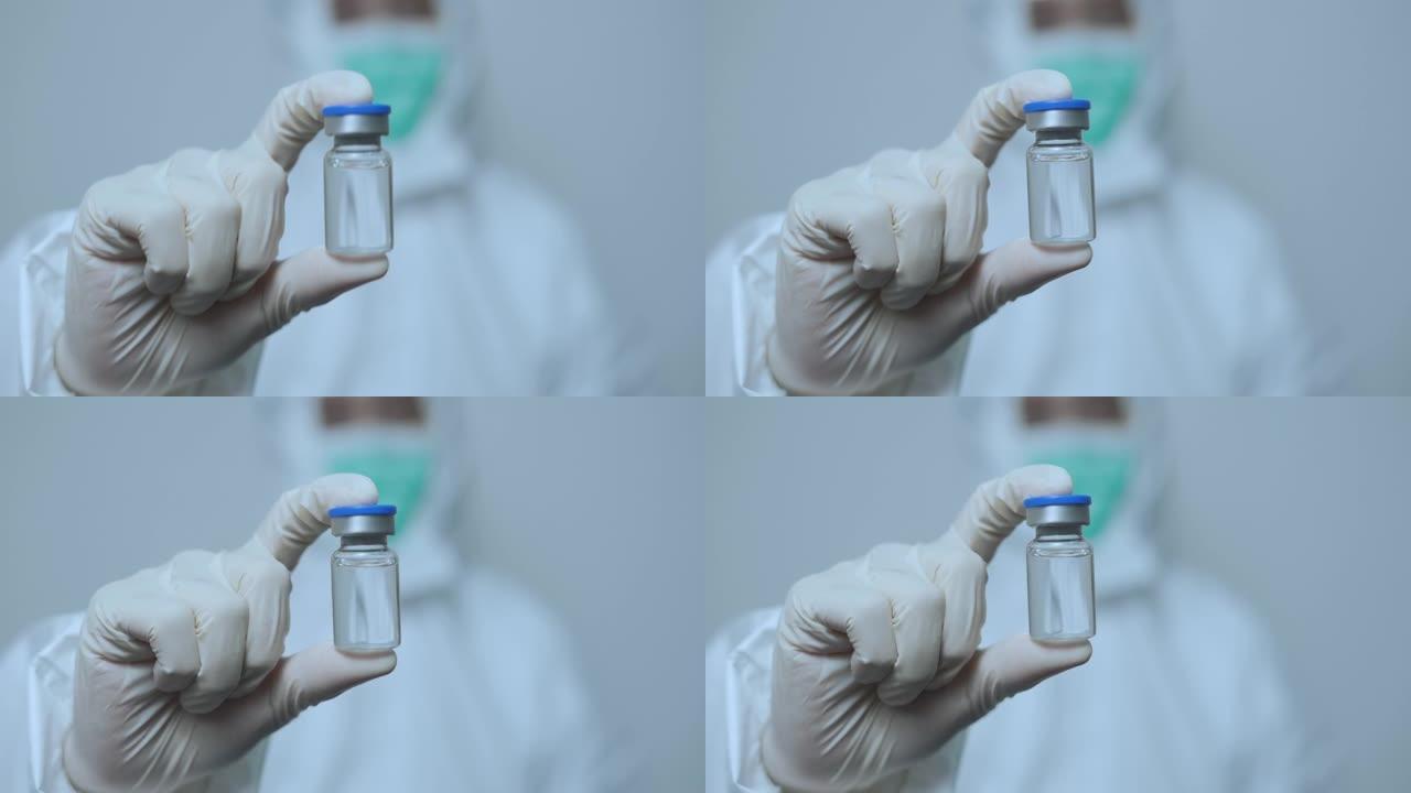 持有抗病毒疫苗小瓶的亚洲医生