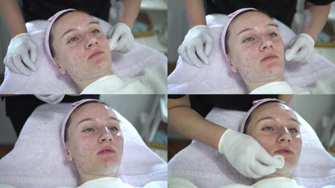 美容师在美容院对面部皮肤进行微晶磨皮手术后清洁年轻女性的面部。美容和专业护肤
