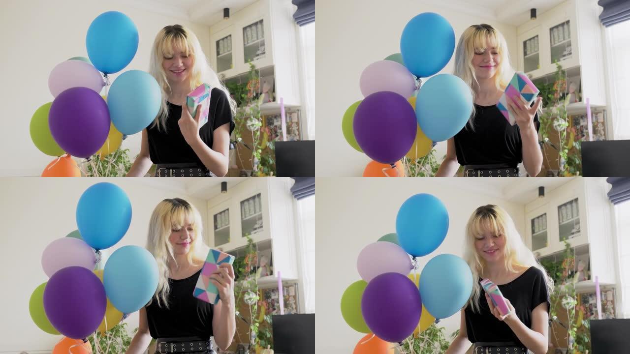 生日派对，带彩色气球和惊喜礼盒的女少年