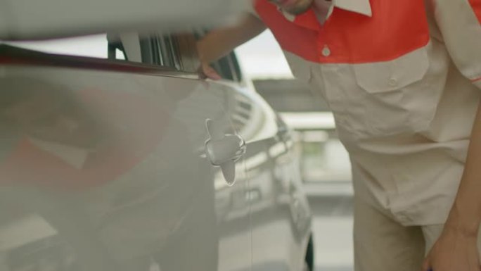 技术人员使用超细纤维布清洁车门