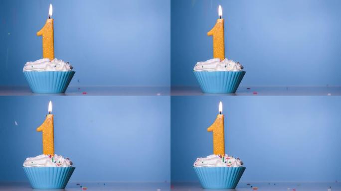 柔和蓝色背景上燃烧的彩色蜡烛一号生日蛋糕。120 FPS。带复制空间的慢动作周年横幅。