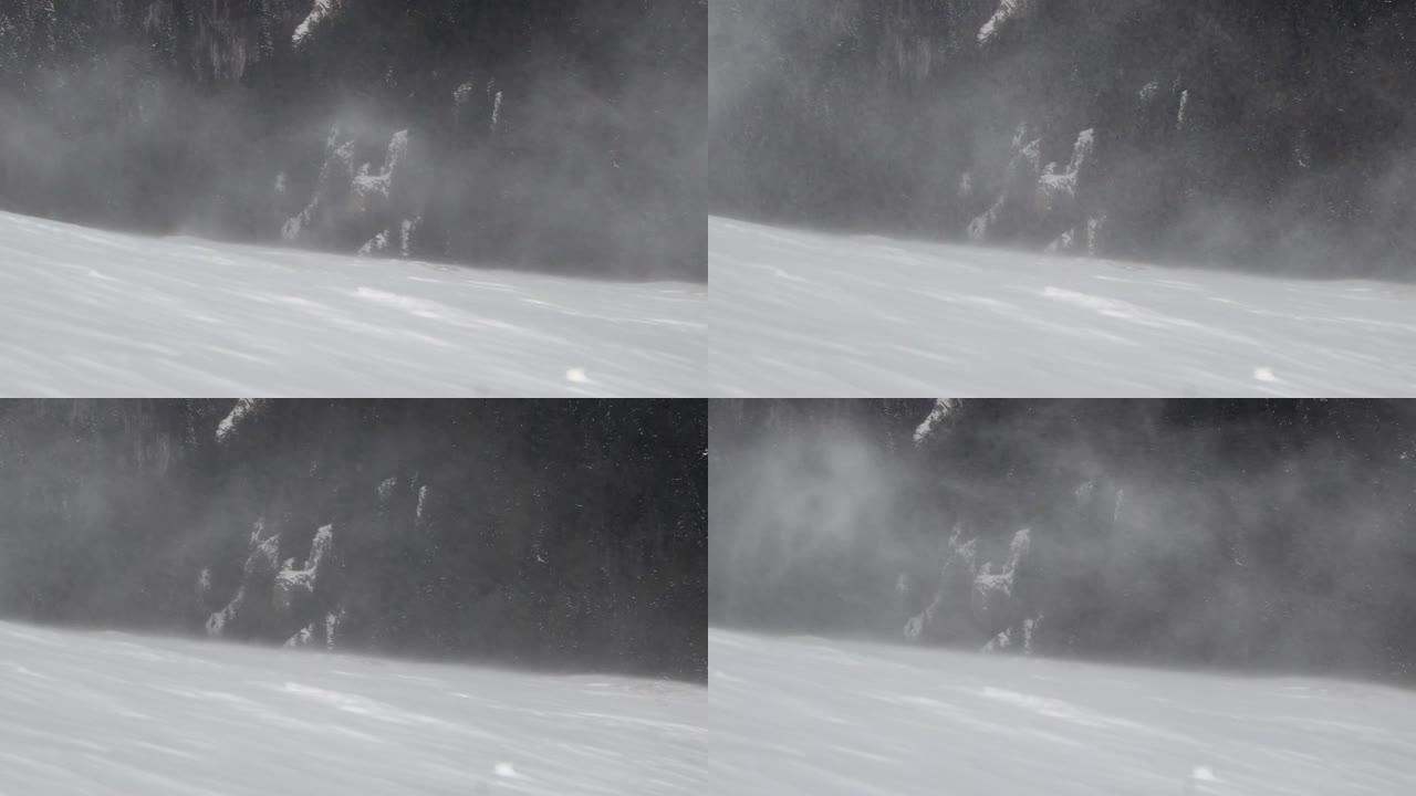 由于山顶山坡上的暴风雪，积雪在空中飘过，特写镜头