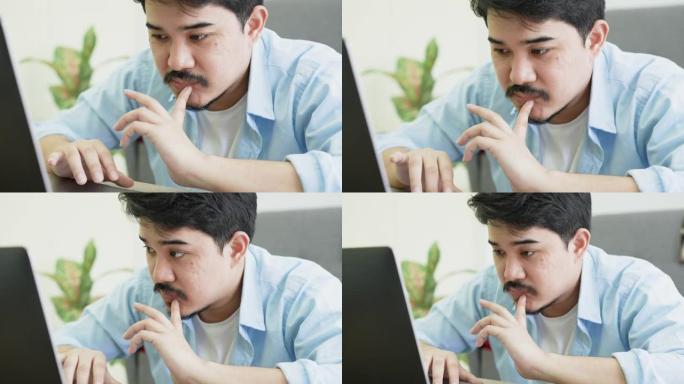 中东男子在笔记本电脑上工作的慢动作场景，在生活方式概念办公室思考公司新项目的战略和规划
