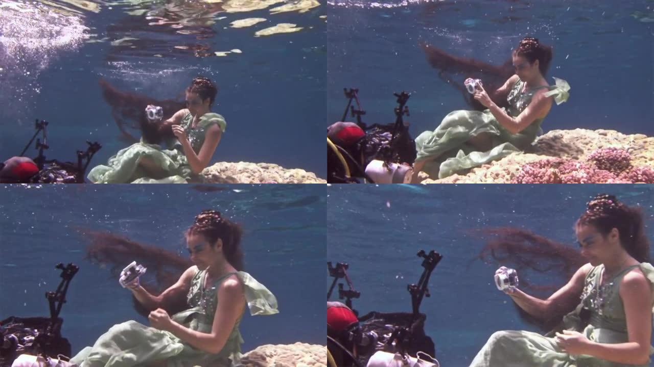 水下模型自由潜水员在红海珊瑚背景上的相机姿势。