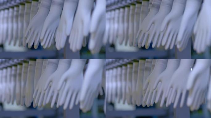 特写，橡胶手套坯料在传送带上旋转。工厂生产橡胶医用手套的现代化设备。4k，普洛雷斯