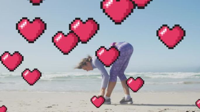 漂浮的红色像素心的动画，在海滩上的女人绑鞋
