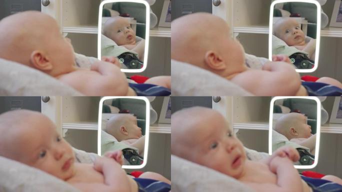 可爱的婴儿躺在家里镜子前的摇椅上，面对高加索人3个月大的新生婴儿特写。