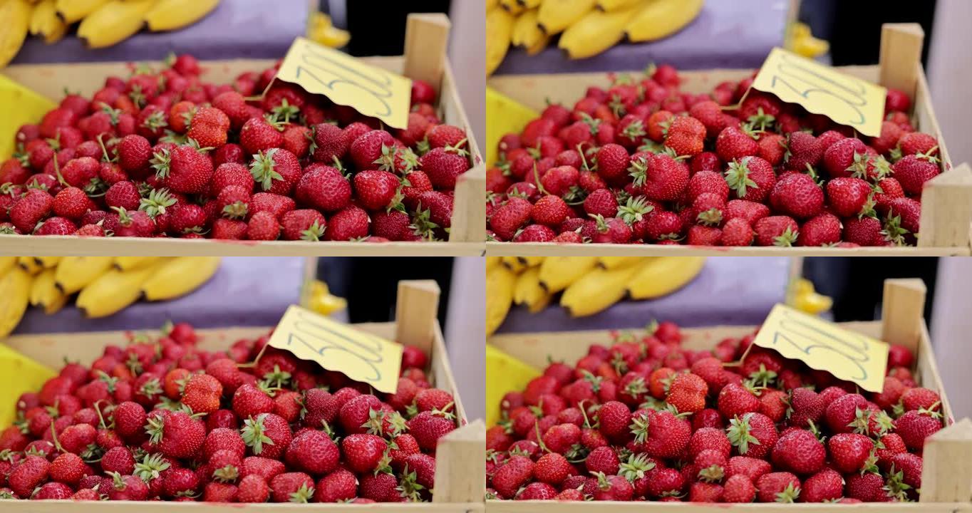 市场上板条箱中的新鲜草莓关闭