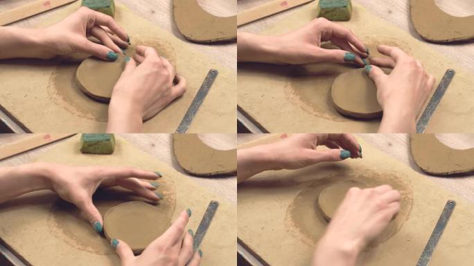 女人制作陶土板，手工制作的特写镜头。
