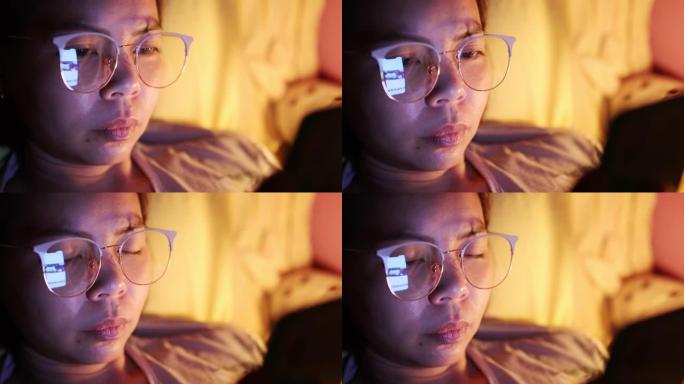 脸部特写年轻亚洲女性睡觉前发短信智能手机