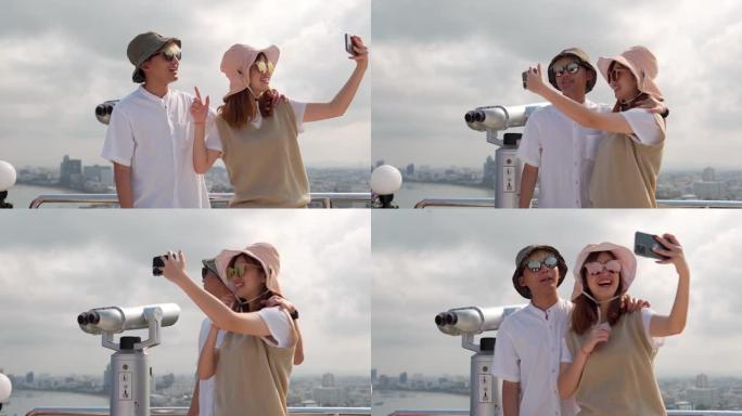 开朗的亚洲年轻夫妇游客在社交媒体上拍照。
