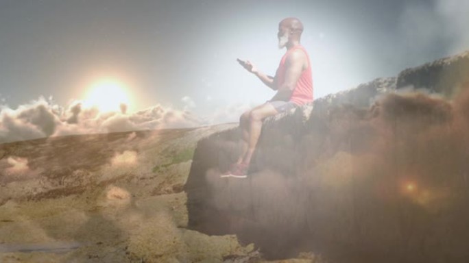 使用坐在岩石上的智能手机在老人身上发光的动画