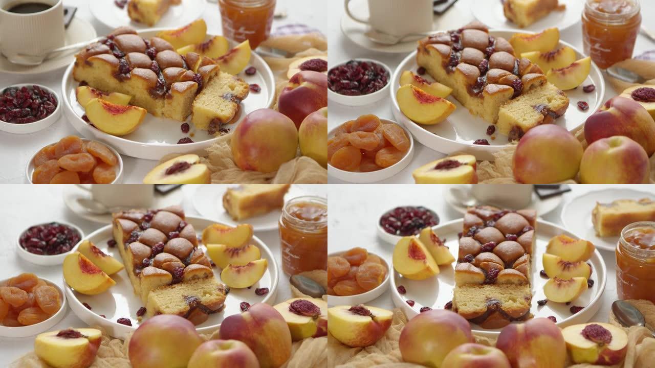美味的自制桃子或油桃蛋糕，新鲜水果，果酱，石头上的蔓越莓背景