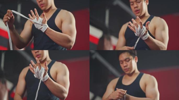 亚洲活跃英俊的运动员男子手拿运动包装手套在健身房锻炼。年轻的运动员拳击手在体育场进行拳击运动后充满信