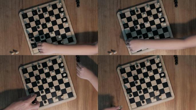 一个女孩和父亲下棋游戏，孩子学习下棋。