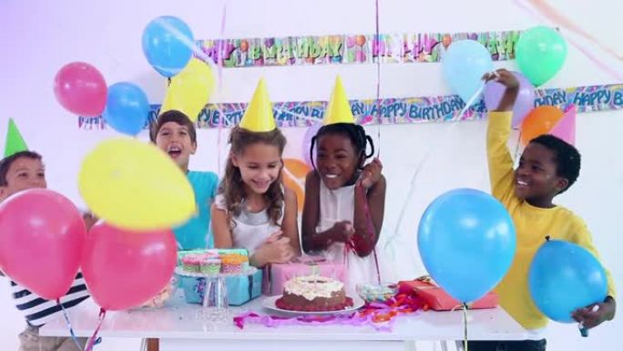 孩子们在生日蛋糕上吹蜡烛并在聚会上聚会的动画