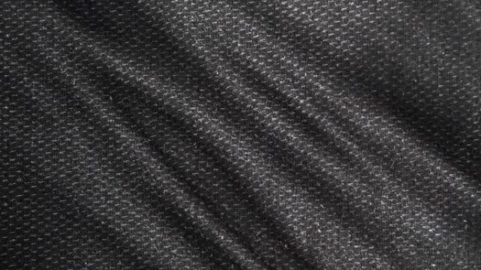 黑色织物布料是波浪的。时尚图案，细节粗麻布。