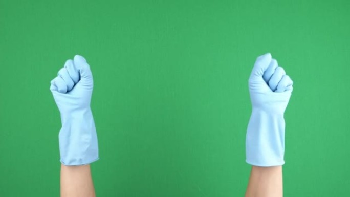 戴着蓝色防护橡胶手套的女性手在绿色chromakey背景上紧握和松开手指。4k视频