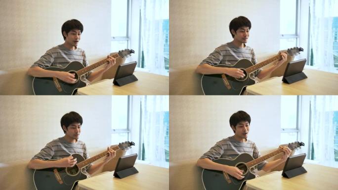 快乐的亚洲男人在家弹吉他