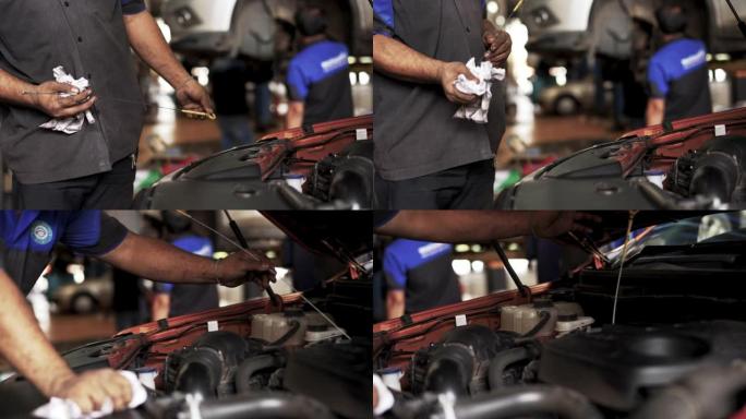 机械师检查汽车润滑油状态油位。
