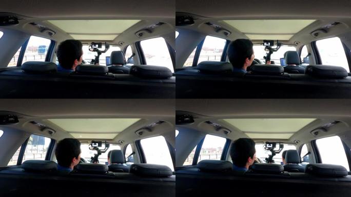 从一名男子在4k公路旅行中拍摄他的朋友的背后观看车内