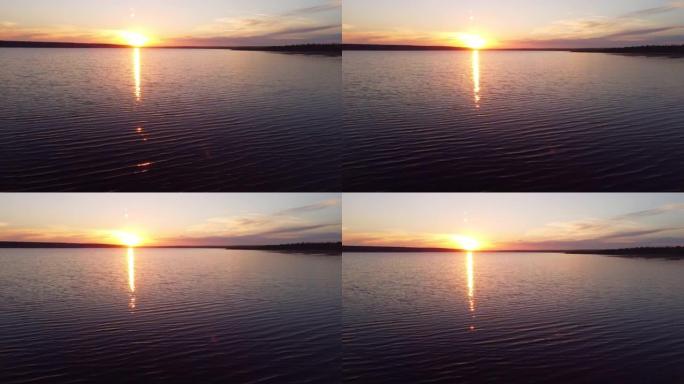 在充满活力的风景日落下，鸟瞰图飞越湖海静止水面