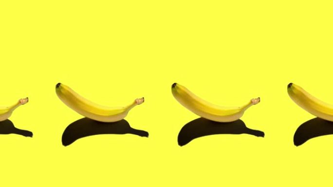 无缝循环动画与成熟的黄色香蕉隔离在明亮的背景。中午太阳的硬阴影