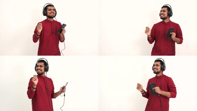 戴着耳机和平板电脑听音乐的印度男子