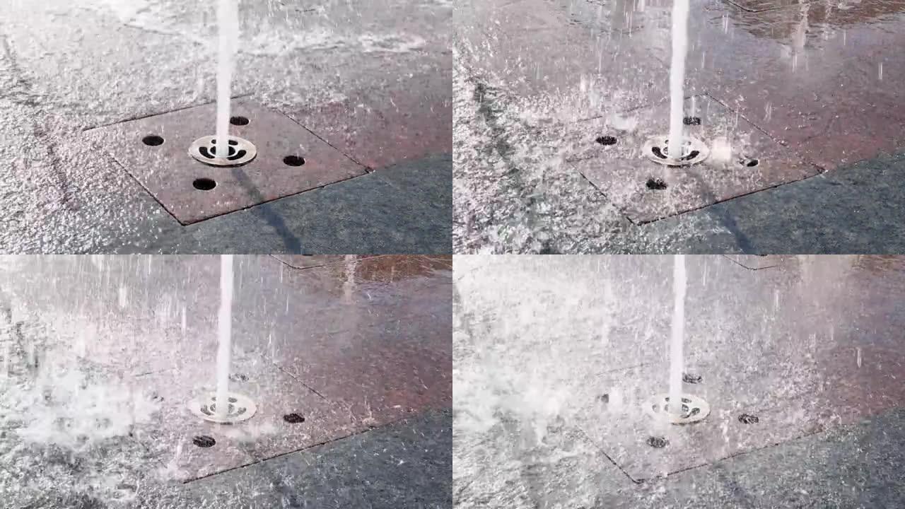 广场上的人流喷泉，特写镜头。水从街道上的地板喷泉从嵌入市中心地面的间歇泉喷嘴溅出。