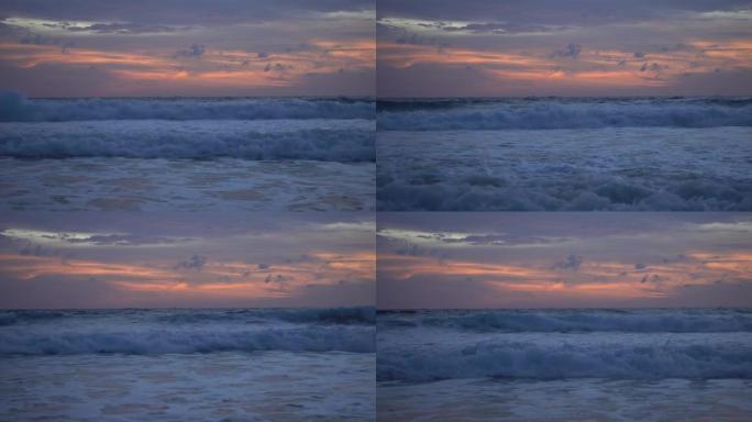 戏剧性的海上日落或日出燃烧的紫色天空和闪亮的白浪撞击在沙滩上美丽的光线反射在海面上惊人的风景或海景背
